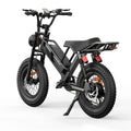 All-terrain fat tire electric bike with rear suspension, black frame, and rack on white background